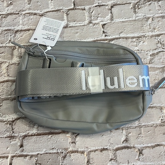lululemon athletica Handbags - Lululemon everywhere, belt bag, silver drop with white Lululemon on strap